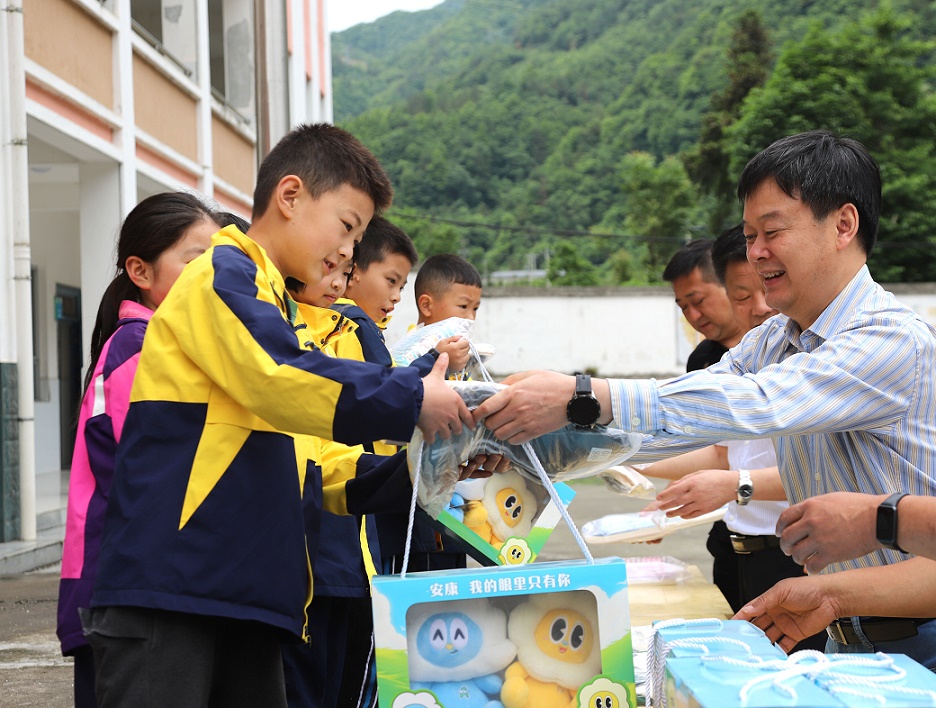 2. 何涛为八道小学儿童发放礼物.JPG
